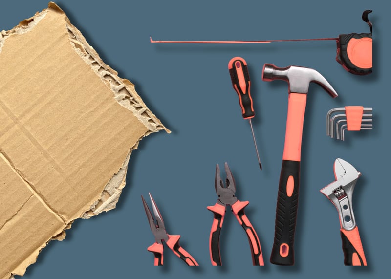 Assortment of tools next to corrugated board