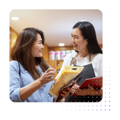 Two Women Looking at Products